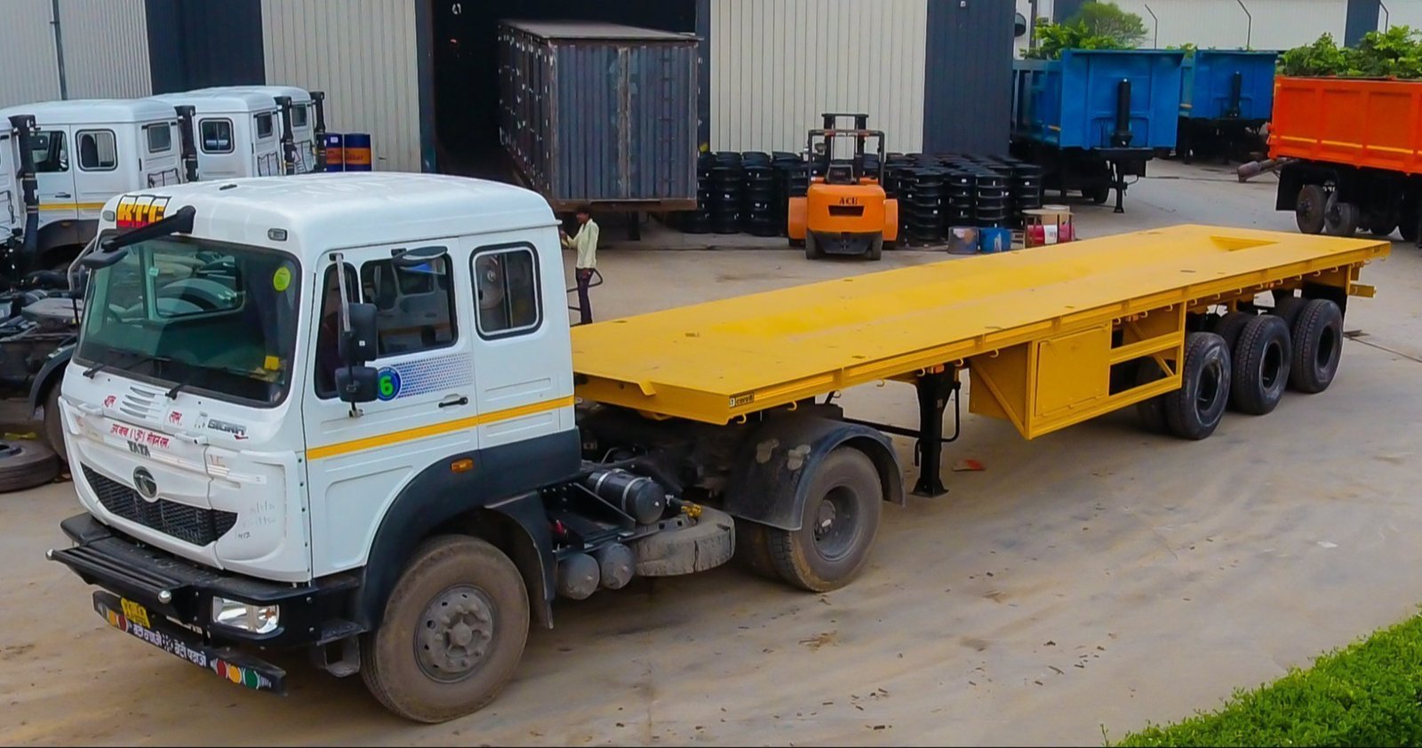 Trailer truck with an open flatbed deck